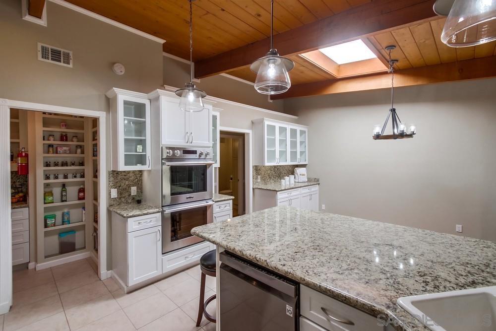 Kitchen with wall oven and walk-in pantry